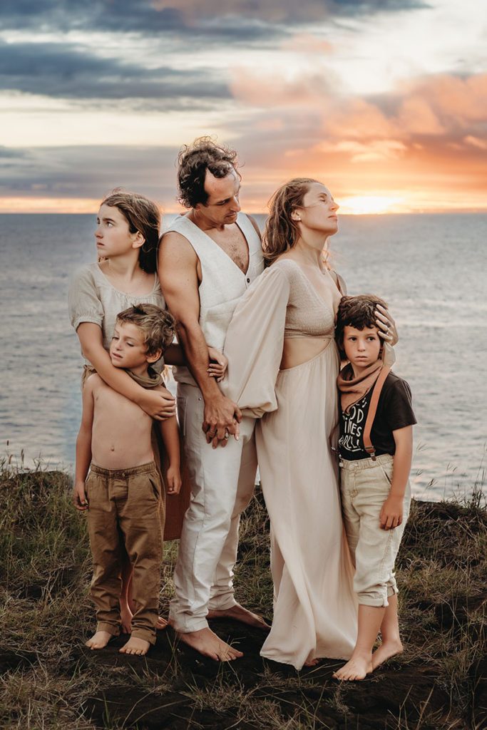 Caryn Scanlan South Shore Photographer photograph of a family on a cliff in front of the ocean in South Point Hawaii