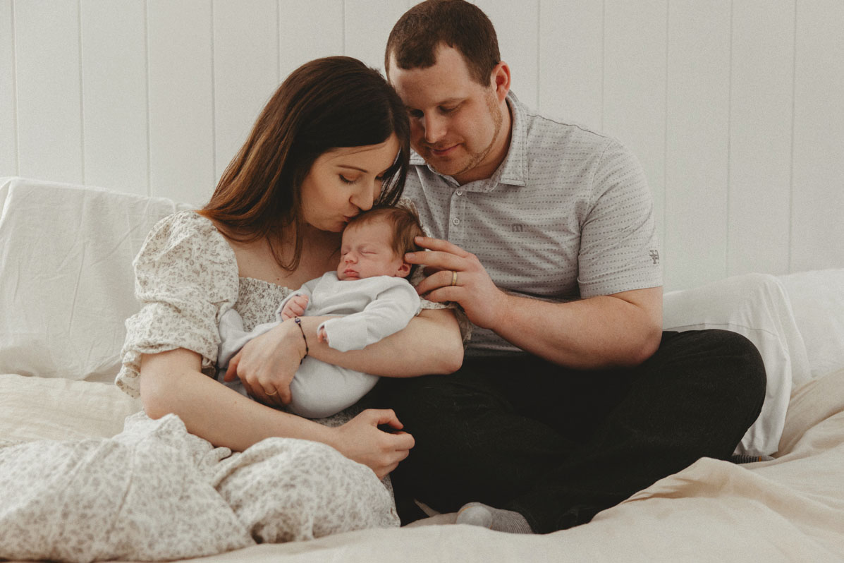 Cape Cod in-home newborn session — candid family moment by Caryn Scanlan