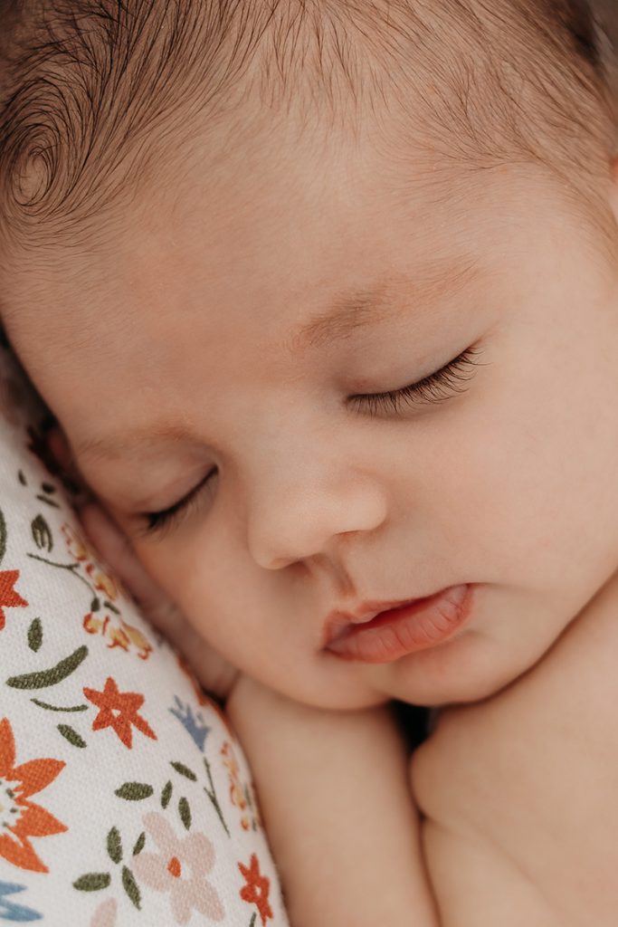 Boston + Cape Cod Newborn Photographer photo of a baby's face with beautiful eyelashes by Caryn Scanlan