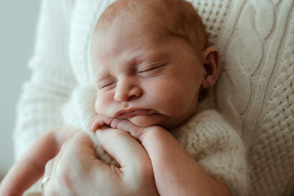 Cape Cod Newborn Photographer photo of a newborn being held by his dad