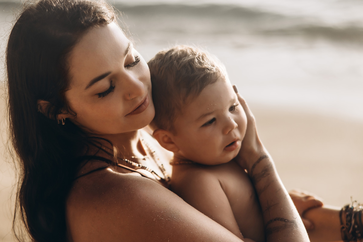 Cape Cod Family & Maternity Photographer 18 Photo of a mom and embracing her baby boy on the beach by Cape Cod family photographer Caryn Scanlan