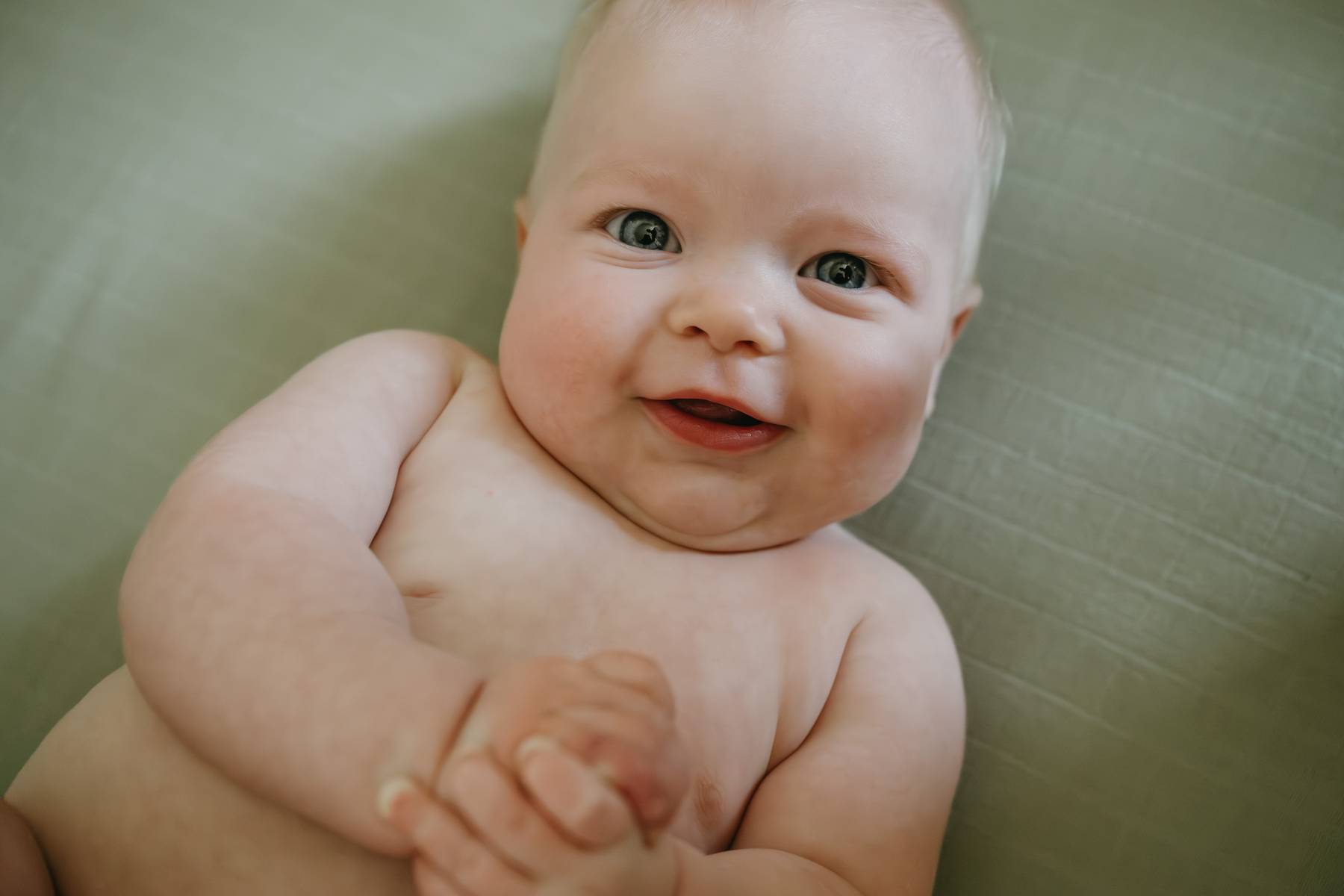 6 month old baby session on the South Shore MA smiling baby in his crib
