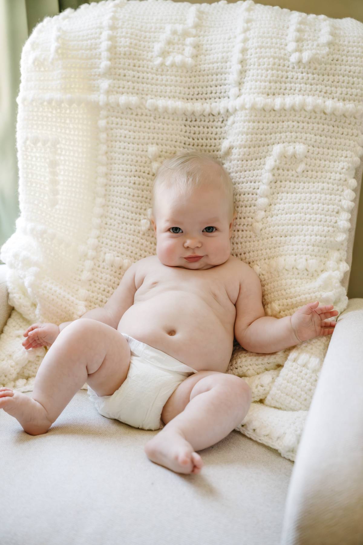 6 month old baby session on the South Shore MA smiling baby on a chair