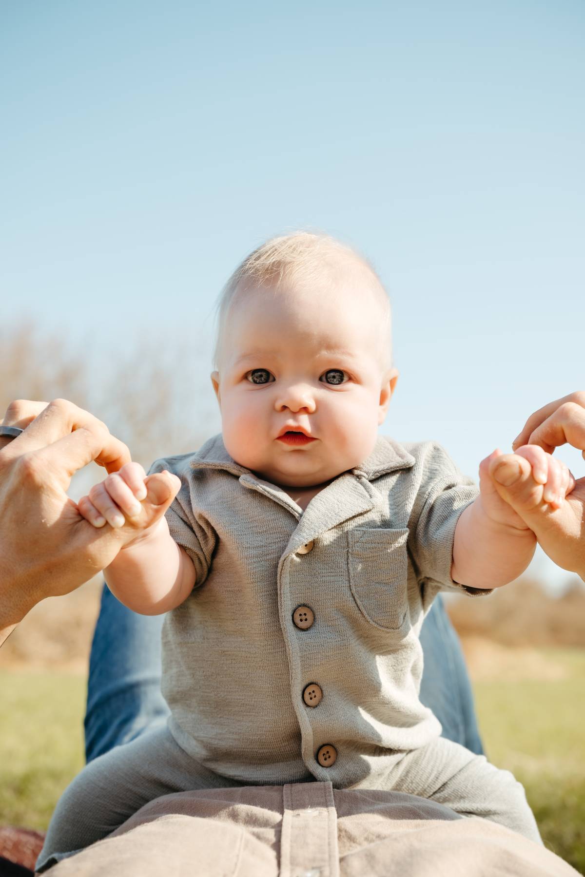 6 month old baby session on the South Shore MA sitting on his dad outdoors